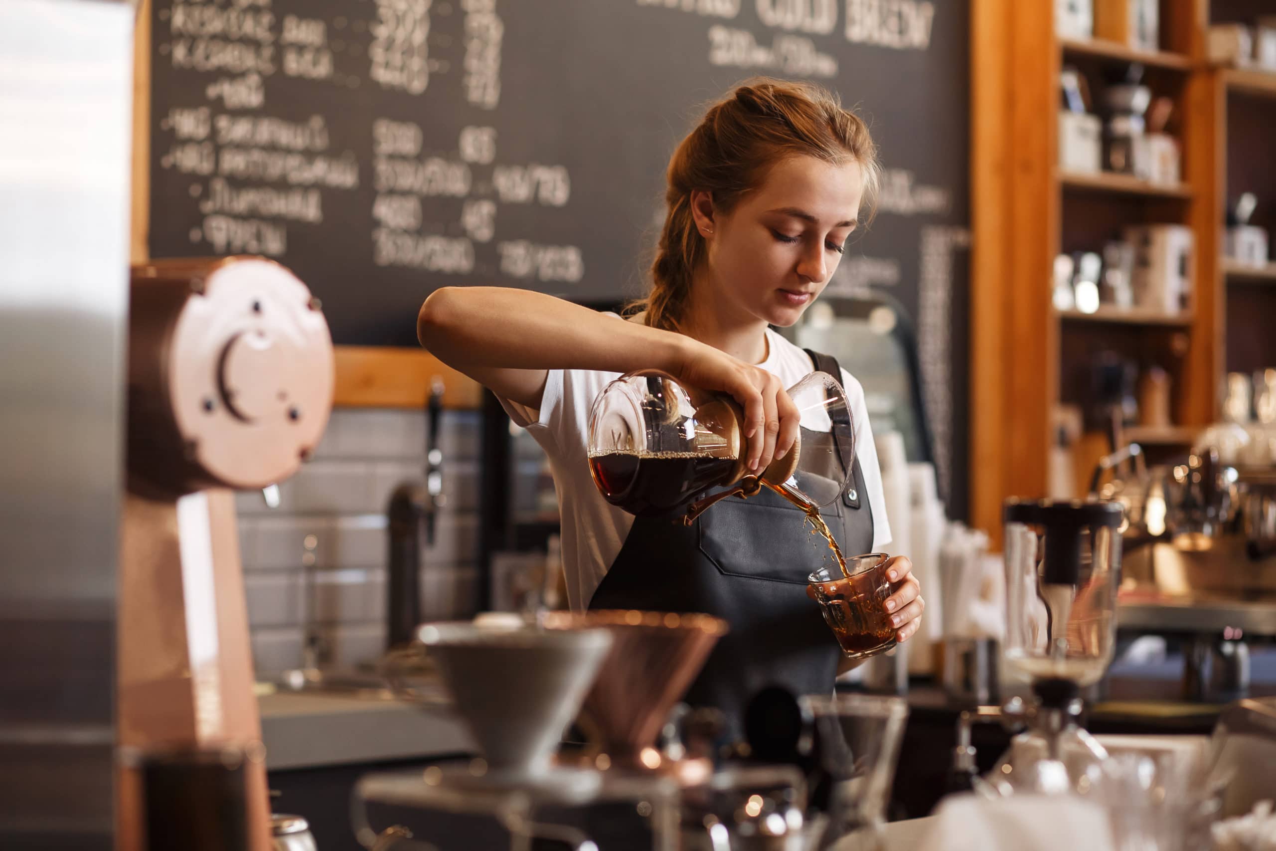 A barista works stress-free through earned wage access.