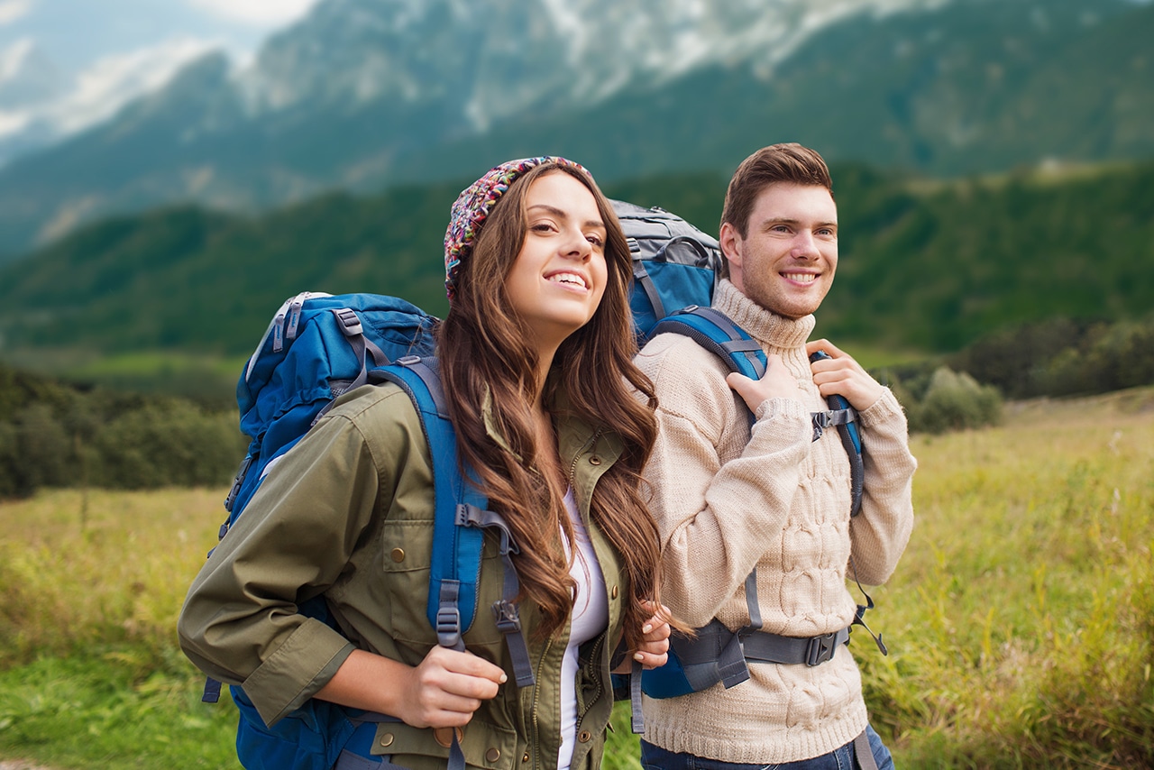 happy couple hiking in nature to have fun without spending money