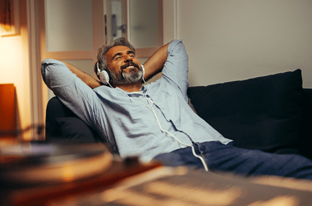 A man relaxing with peace of mind due to financial wellness.